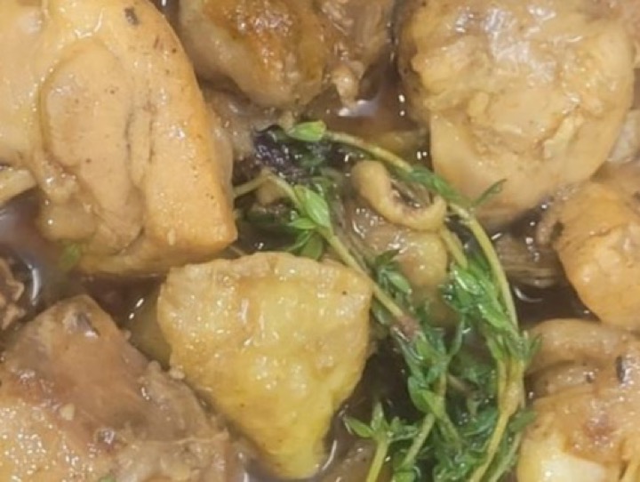 Curry goat served with rice and peas