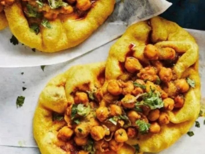 Two doubles — curried chickpeas on soft fried bara, topped with fresh coriander